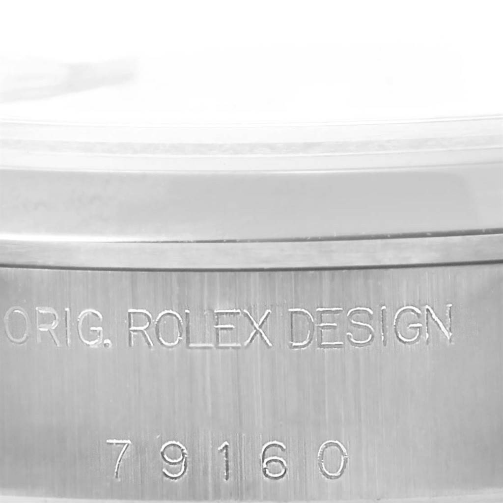 The image shows a close-up of the side of a Rolex Date 79160 Women's Stainless Steel Pink Dial 79160 Women's Stainless Steel Pink Dial watch, revealing the engraved model number "79160" and "ORIG. ROLEX DESIGN."