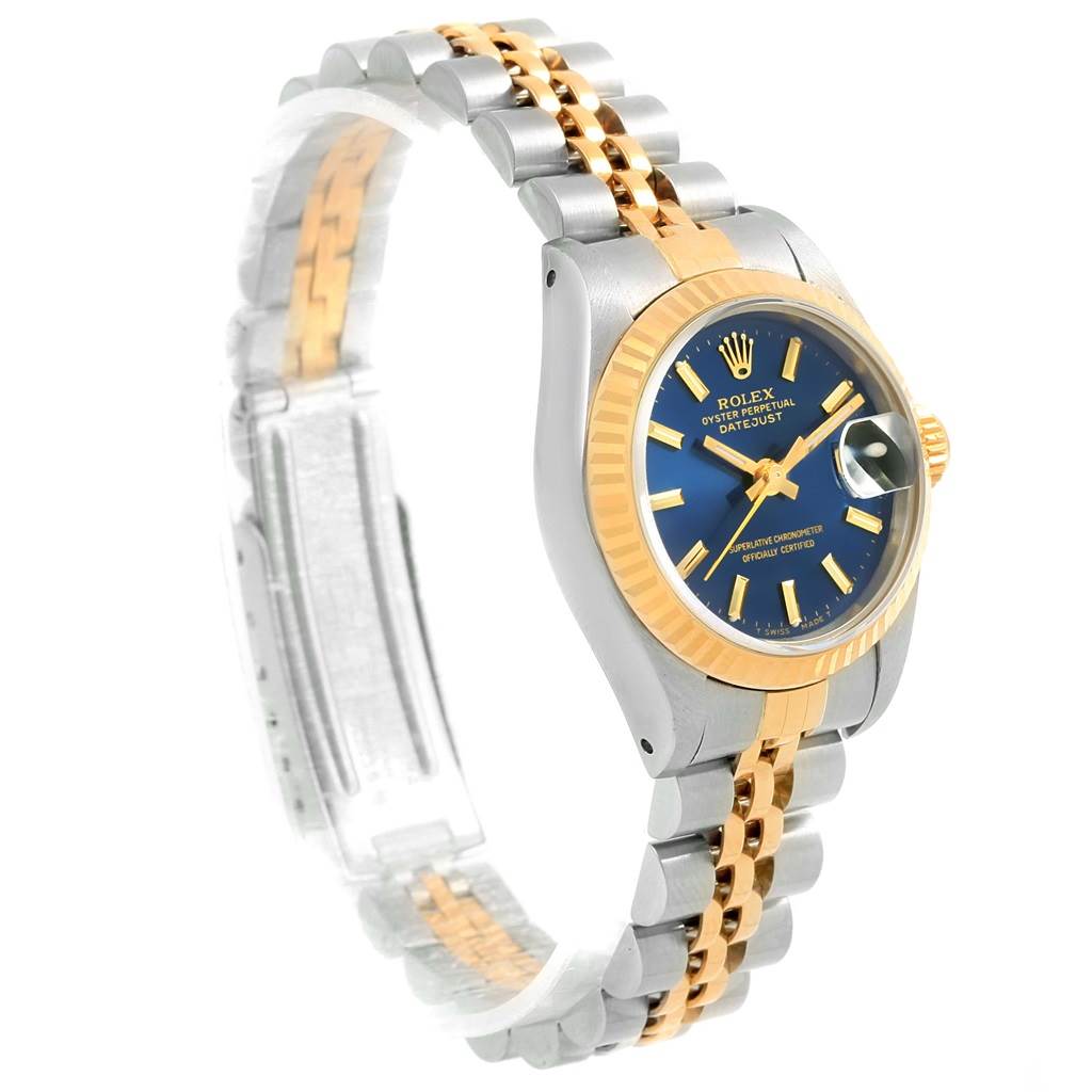 The image shows a side view of the Rolex Date 69173 Women's Stainless Steel Blue Dial 69173 Women's Stainless Steel Blue Dial model, highlighting its gold bezel, blue dial, and two-tone bracelet.