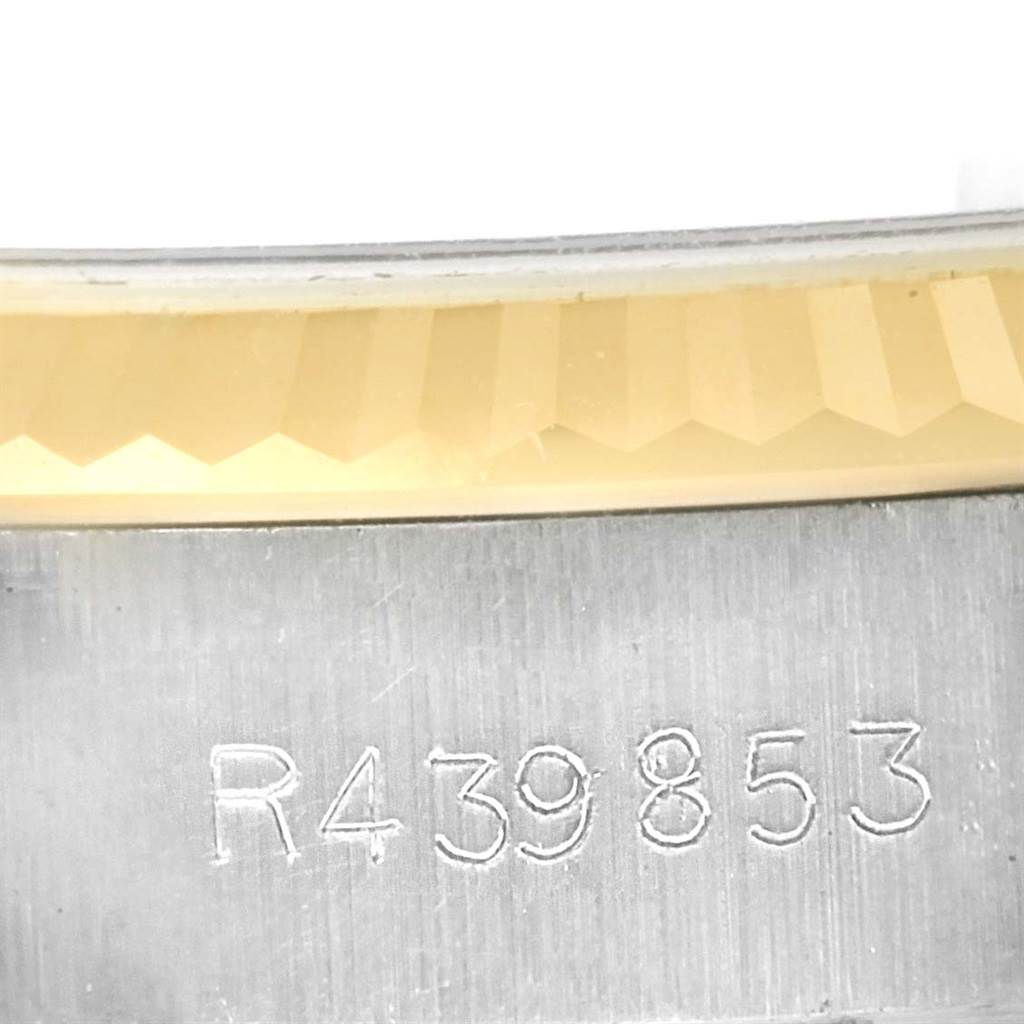 This close-up image shows the engraved serial number on the case of a Rolex Date 69173 Women's Stainless Steel Blue Dial 69173 Women's Stainless Steel Blue Dial model watch.