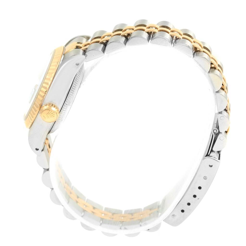 The image shows a Rolex Date 69173 Women's Stainless Steel Blue Dial 69173 Women's Stainless Steel Blue Dial model watch from a side angle featuring the case, crown, and two-tone bracelet.