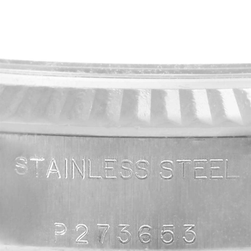 This image shows a close-up of the serial number and stainless steel marking on the side of a Rolex Date 79174 Women's Stainless Steel Blue Dial 79174 Women's Stainless Steel Blue Dial model watch case.