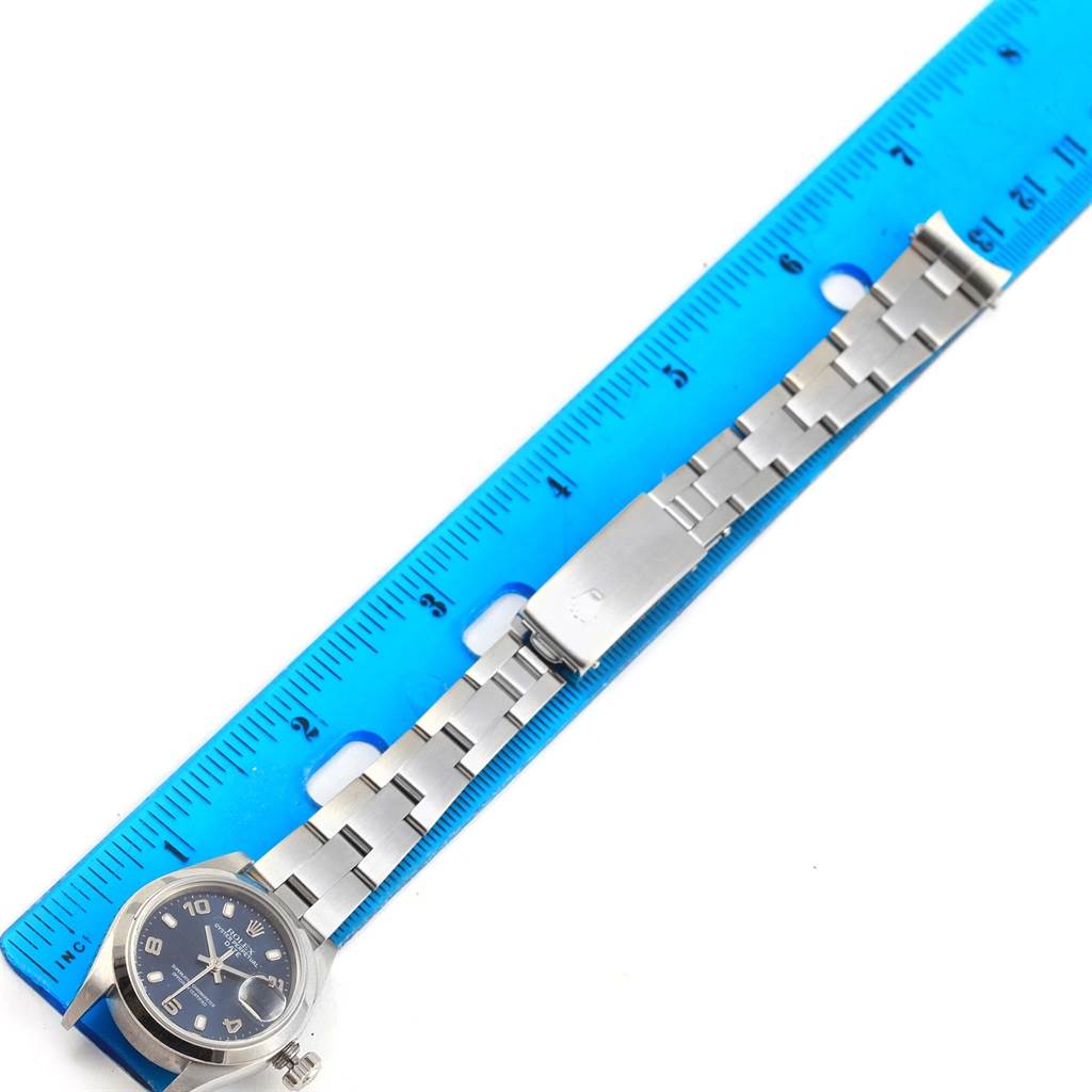 The image shows a Rolex Date 79240 Women's Stainless Steel Blue Dial 79240 Women's Stainless Steel Blue Dial model watch with a metal bracelet laid alongside a ruler, displaying the watchband length.