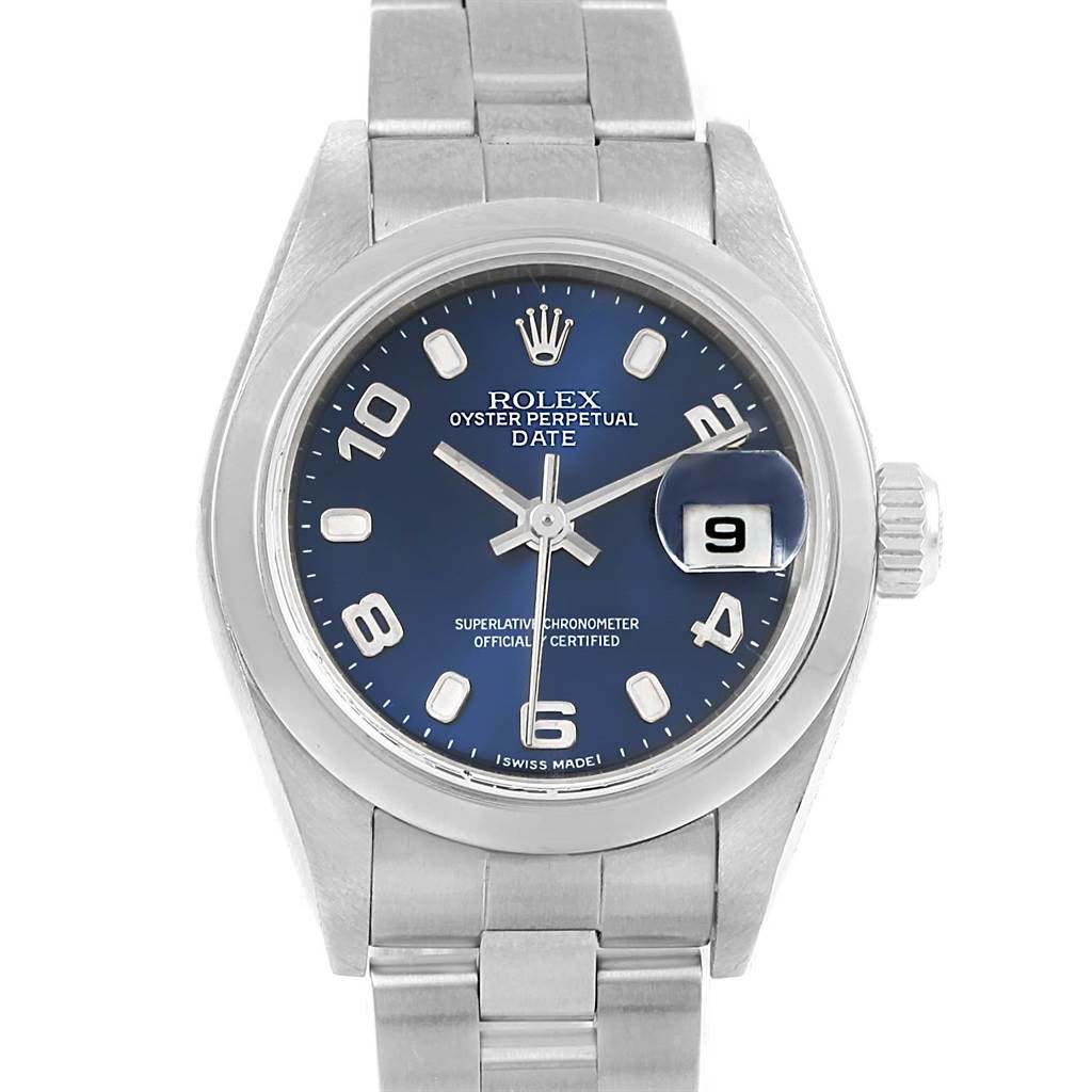 The image shows a front view of a Rolex Oyster Perpetual Date watch, highlighting its blue dial, bracelet, and date display.
