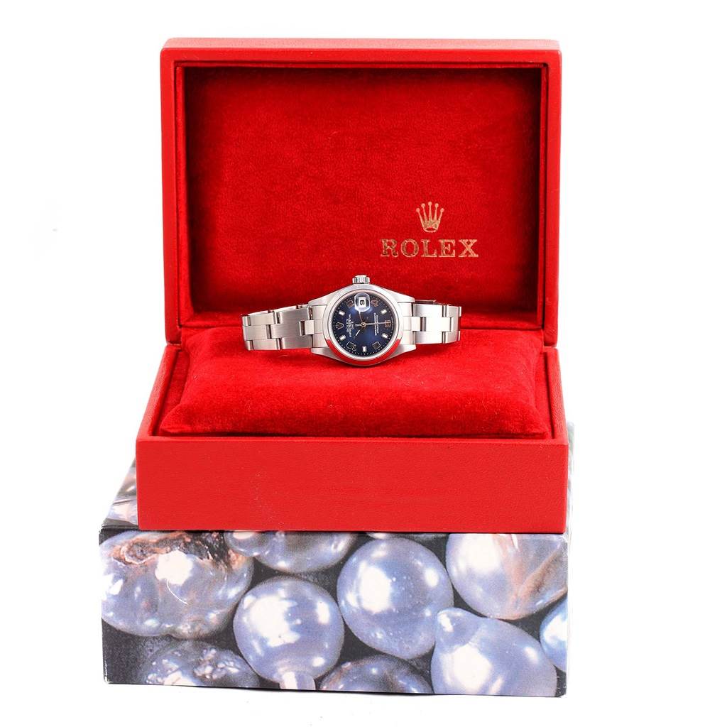 The Rolex Date 79240 Women's Stainless Steel Blue Dial 79240 Women's Stainless Steel Blue Dial model is shown front-facing in its red box with the bracelet and watch face visible.