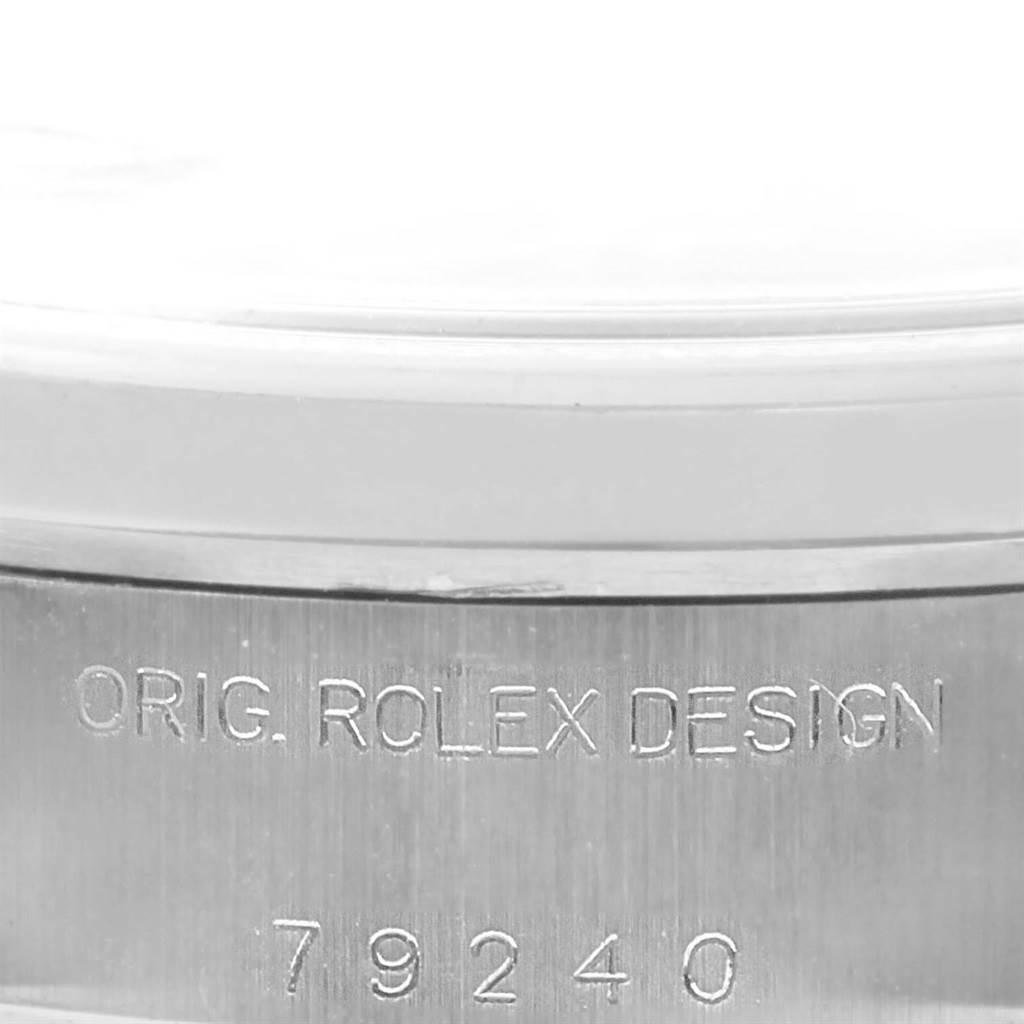 The image shows a close-up of the side case of a Rolex Date 79240 Women's Stainless Steel Blue Dial 79240 Women's Stainless Steel Blue Dial model, with the engraving "ORIG. ROLEX DESIGN 79240."
