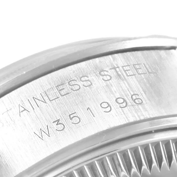 This image shows a close-up angle of the case back and the serial engraving on a Rolex Date 69190 Women's Stainless Steel Blue Dial 69190 Women's Stainless Steel Blue Dial model watch.