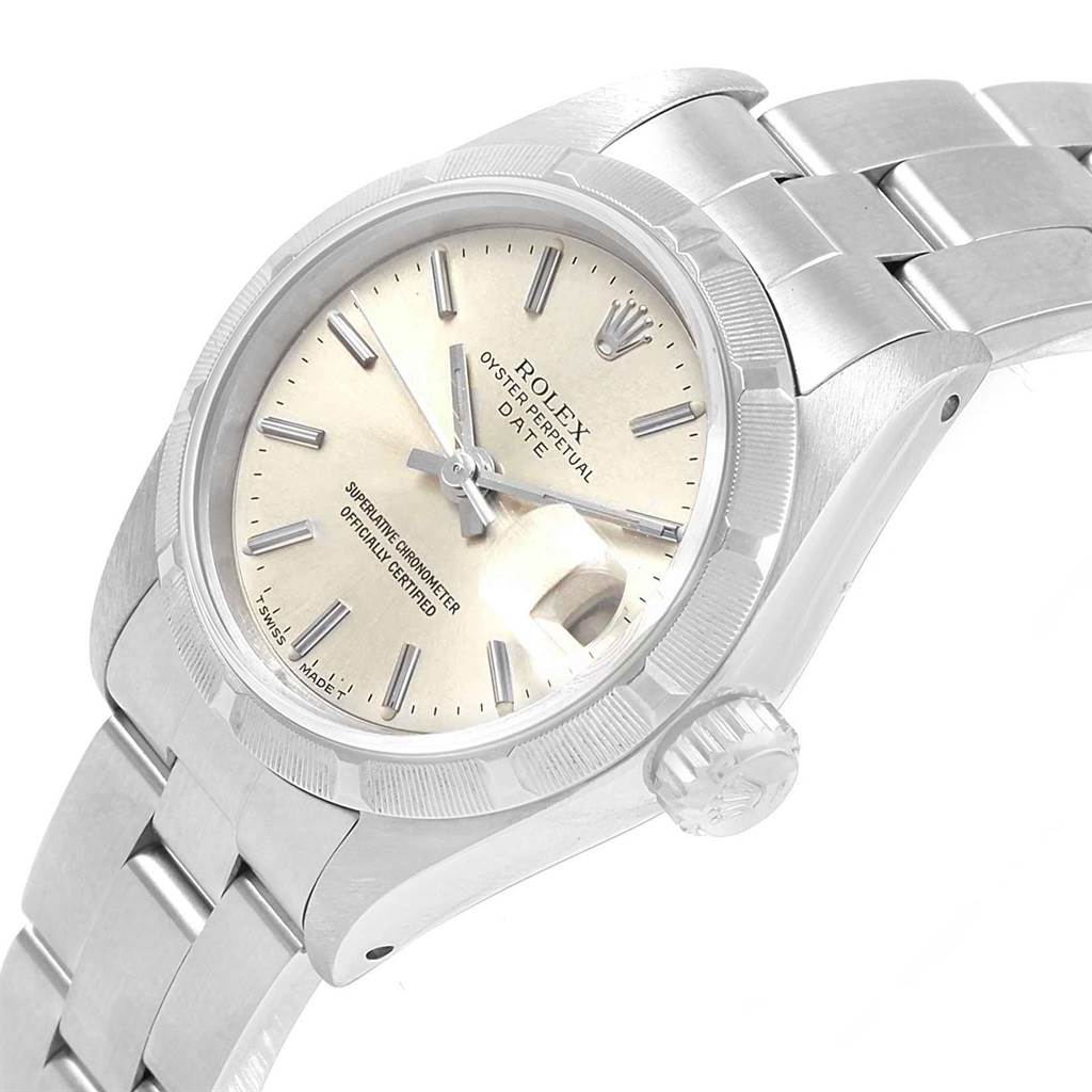 The image shows a Rolex Date 69190 Women's Stainless Steel Silver Dial 69190 Women's Stainless Steel Silver Dial model watch from an angled side view, featuring the dial, bezel, crown, and part of the bracelet.