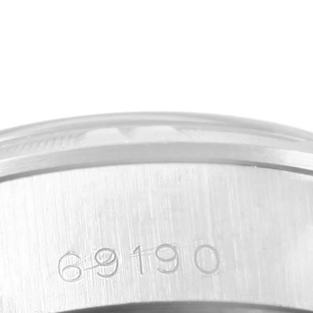 This close-up image shows the side case of a Rolex Date 69190 Women's Stainless Steel Silver Dial 69190 Women's Stainless Steel Silver Dial model watch with the model number engraved.