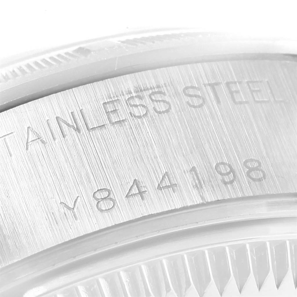 This close-up image shows the stainless steel case and serial number engraving of a Rolex Date 79190 Women's Stainless Steel Silver Dial 79190 Women's Stainless Steel Silver Dial model watch.