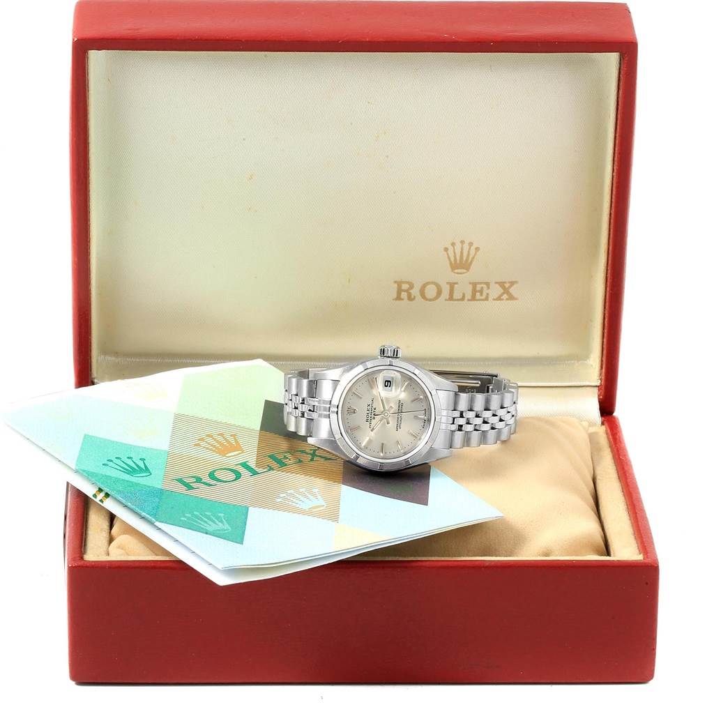 The image shows a Rolex Date 79190 Women's Stainless Steel Silver Dial 79190 Women's Stainless Steel Silver Dial model watch, laid on its opened box with accompanying papers visible.