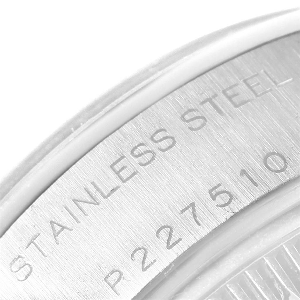 This image shows a close-up of the case back of the Rolex Date 79160 Men's Stainless Steel Black Dial 79160 Men's Stainless Steel Black Dial model, with "Stainless Steel" and a serial number engraved.