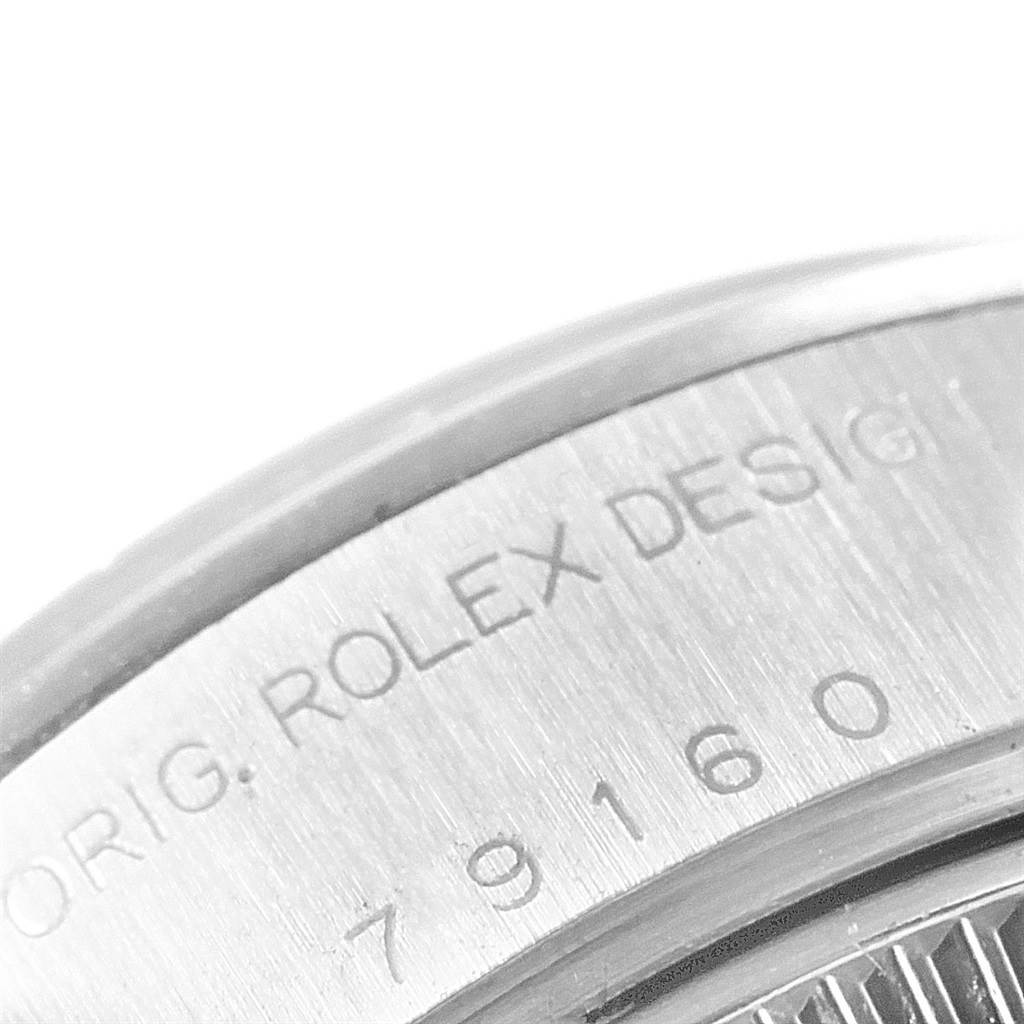 The image shows a close-up of the caseback edge of a Rolex Date 79160 Men's Stainless Steel Black Dial 79160 Men's Stainless Steel Black Dial model, displaying part of the serial number and "ORIG. ROLEX DESIG".