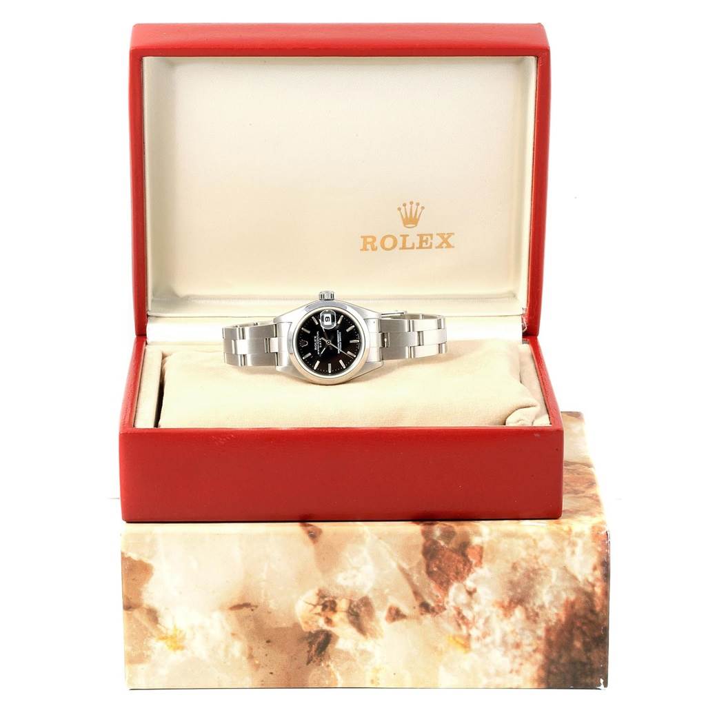 The image shows a Rolex Date 79160 Men's Stainless Steel Black Dial 79160 Men's Stainless Steel Black Dial model watch in its open, angled box, displaying the dial and part of the bracelet.