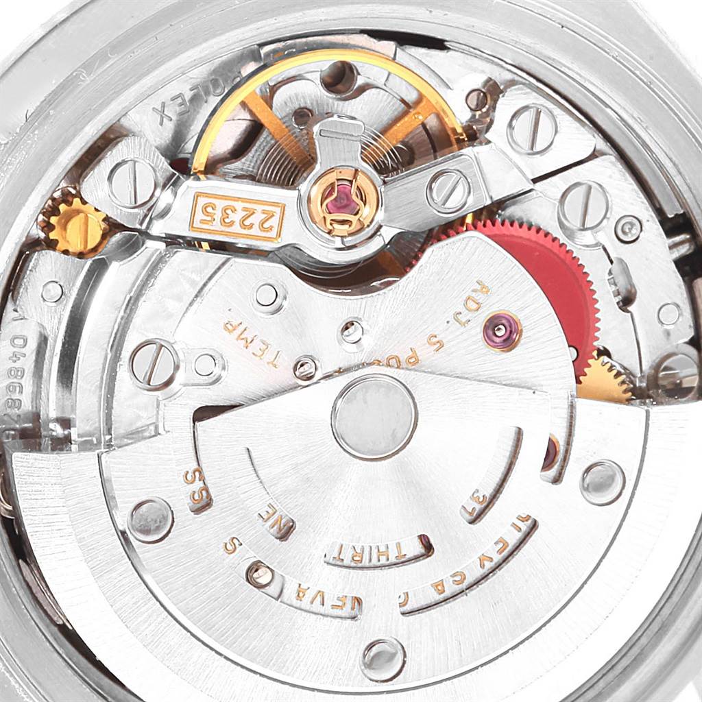 The image shows an internal view of the Rolex Date 79160 Men's Stainless Steel Black Dial 79160 Men's Stainless Steel Black Dial model watch movement, displaying gears and the rotor.