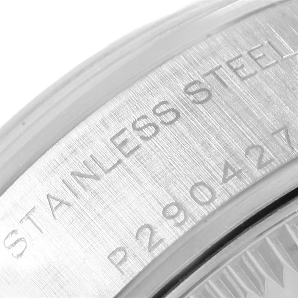 This is a close-up view of the side engraving on a Rolex Date 79160 Women's Stainless Steel White Dial 79160 Women's Stainless Steel White Dial stainless steel watch.