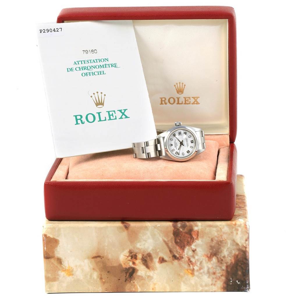 A Rolex Date 79160 Women's Stainless Steel White Dial 79160 Women's Stainless Steel White Dial model watch is shown inside its red box along with the official chronometer certification.