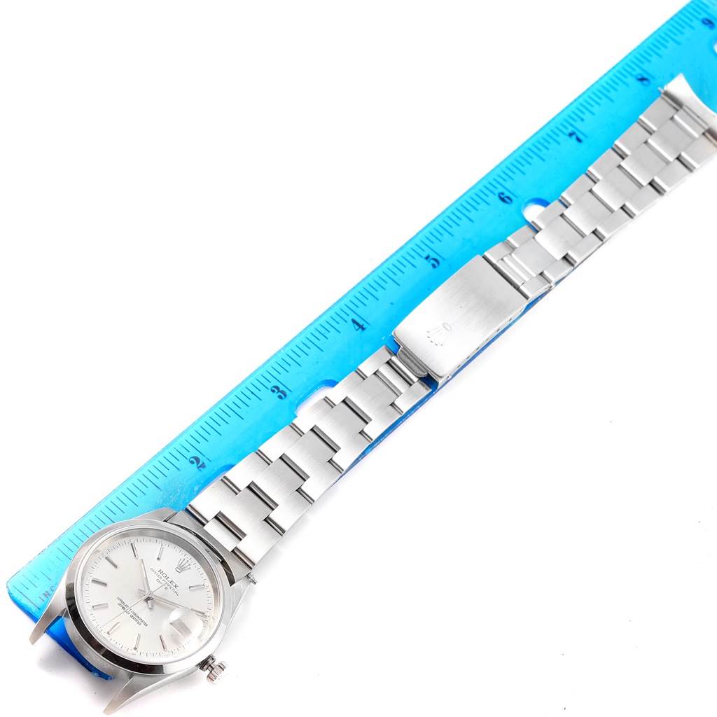 The image shows a Rolex Date 15200 Men's Stainless Steel Silver Dial 15200 Men's Stainless Steel Silver Dial model watch laid flat, with a focus on the entire band and face, placed next to a ruler for measurement.