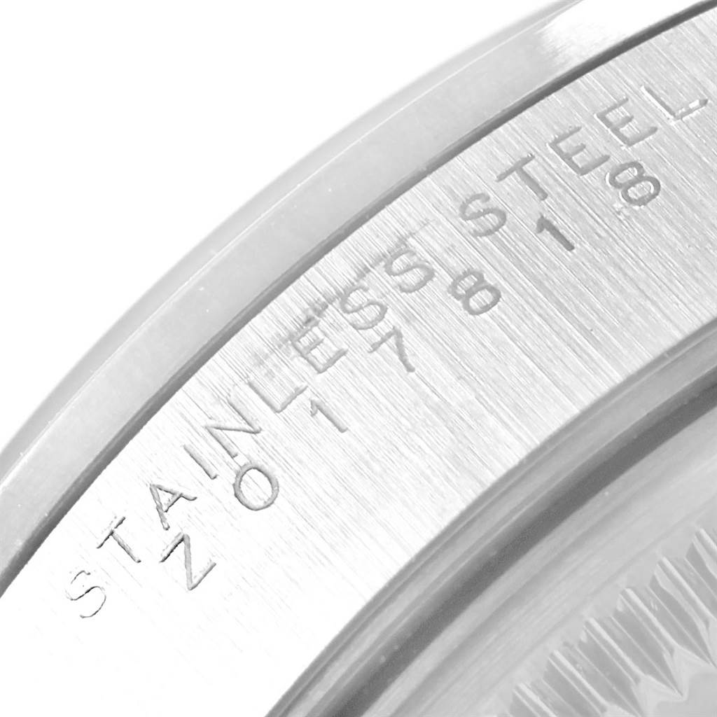 This image shows a close-up angle of the case back edge of a Rolex Date 15200 Men's Stainless Steel Silver Dial 15200 Men's Stainless Steel Silver Dial model watch, highlighting the "Stainless Steel" engraving.