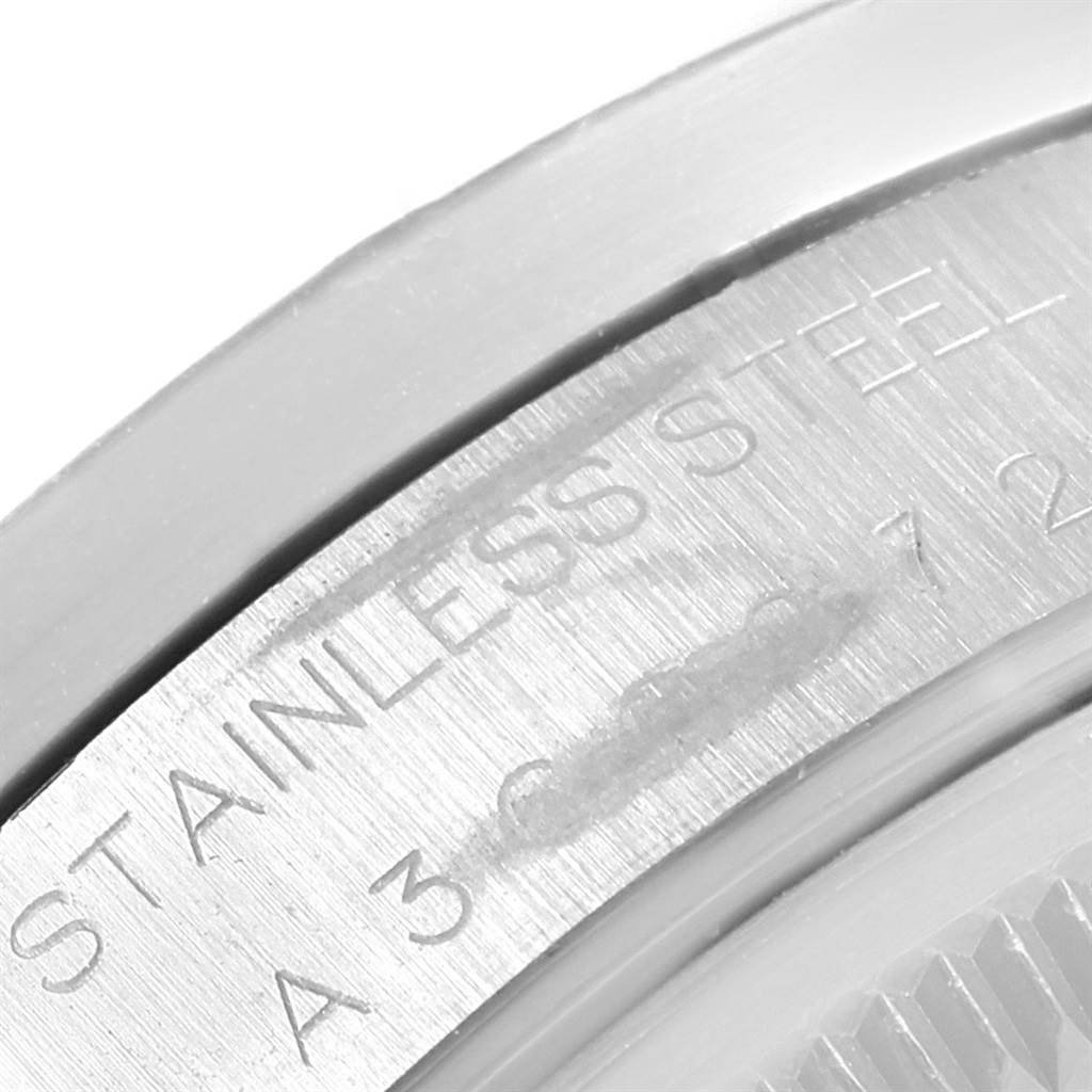 This image shows a close-up angle of the stainless steel back of a Rolex Date 15210 Men's Stainless Steel Blue Dial 15210 Men's Stainless Steel Blue Dial watch, highlighting the engraved text.