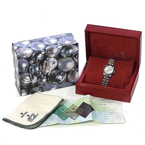 The image shows a Rolex Date 79240 Women
s Stainless Steel Silver Dial 79240 Women
s Stainless Steel Silver Dial watch in its red box, placed next to a decorative outer box and accompanied by a cleaning cloth and documentation.