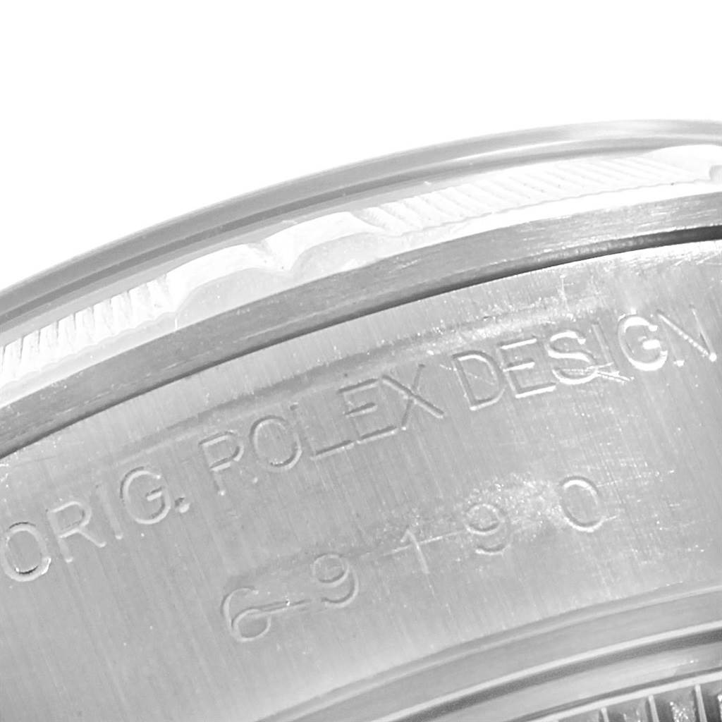 The image shows an angled close-up of the side of a Rolex Date 69190 Women's Stainless Steel Pink Dial 69190 Women's Stainless Steel Pink Dial model, highlighting the engraving on the case.