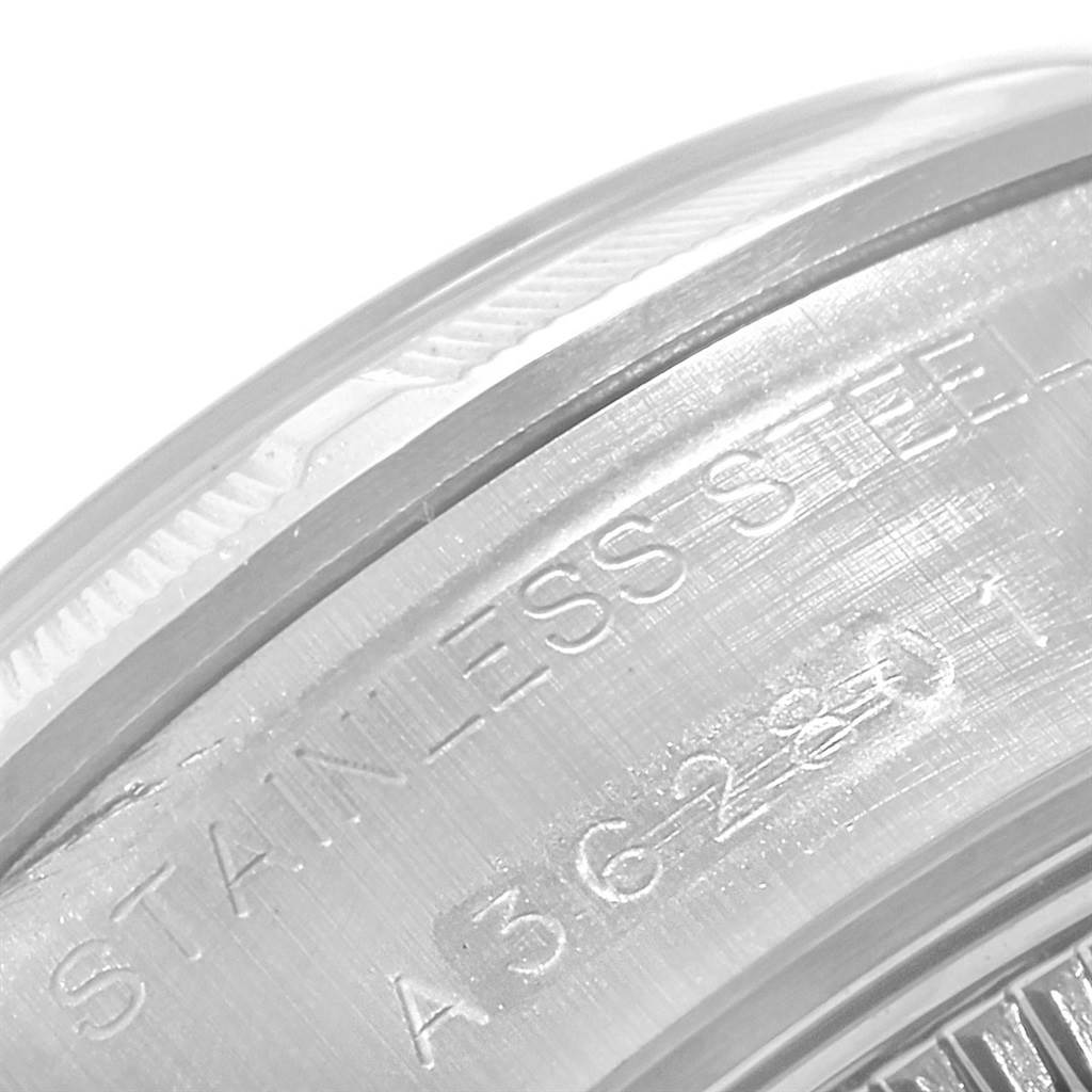 The image displays a close-up of the stainless steel case back of a Rolex Date 69190 Women's Stainless Steel Pink Dial 69190 Women's Stainless Steel Pink Dial model watch, highlighting engravings.