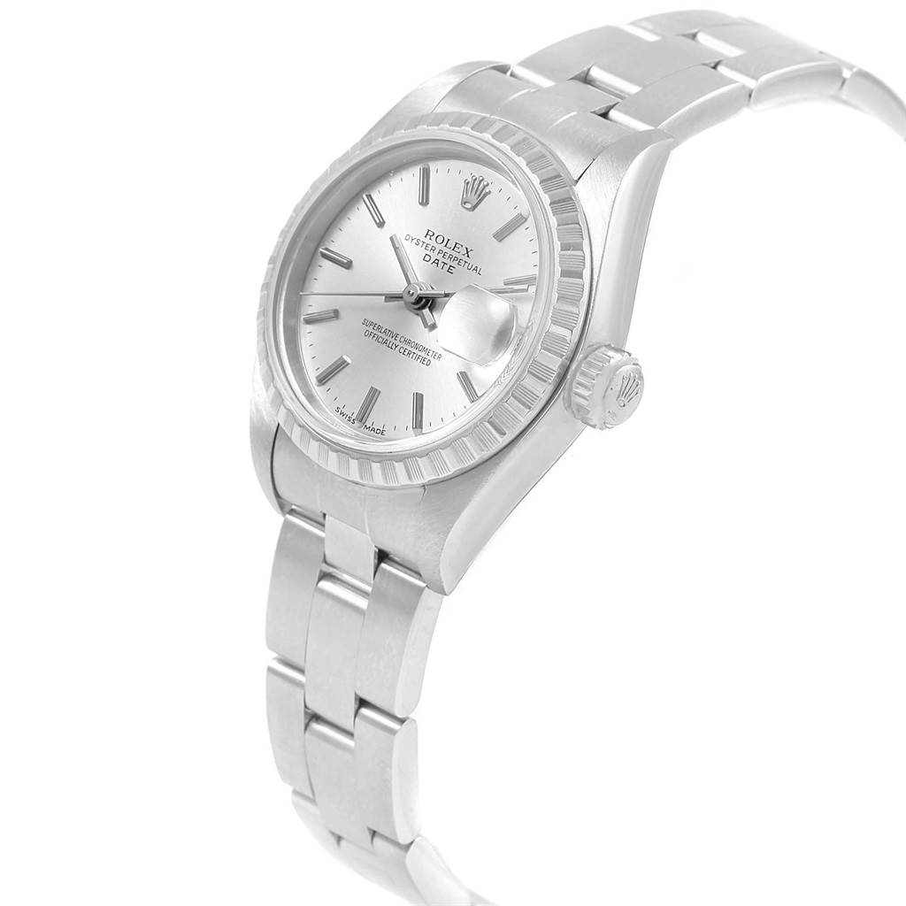 The image shows a Rolex Date 79240 Women's Stainless Steel Silver Dial 79240 Women's Stainless Steel Silver Dial model watch from a tilted angle, highlighting its dial, bezel, crown, and part of the bracelet.