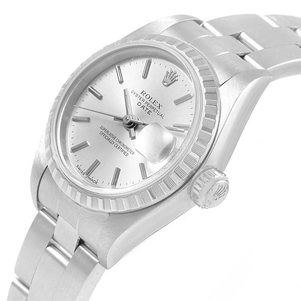 The image shows a side angle of a Rolex Oyster Perpetual Date model watch displaying its bezel, dial, crown, and part of the bracelet.