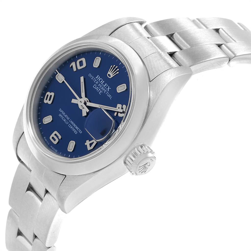 The image shows a side angle of a Rolex Oyster Perpetual Date model watch, highlighting the blue dial, crown, and part of the bracelet.