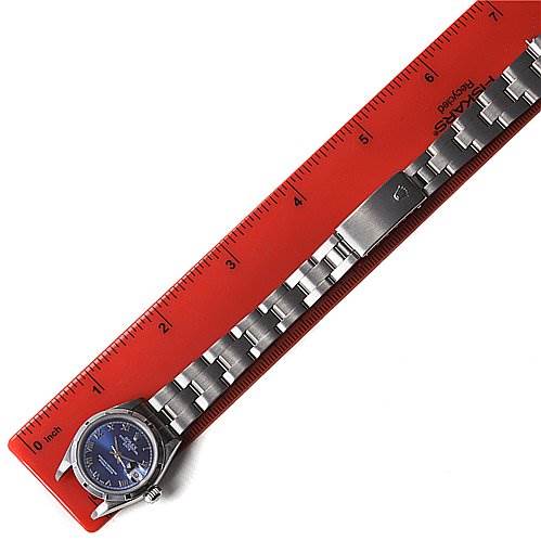 The Rolex Date 69190 Women's Stainless Steel Blue Dial 69190 Women's Stainless Steel Blue Dial watch is shown in a flat angle with its face, bracelet, and buckle visible, placed next to a measuring ruler.