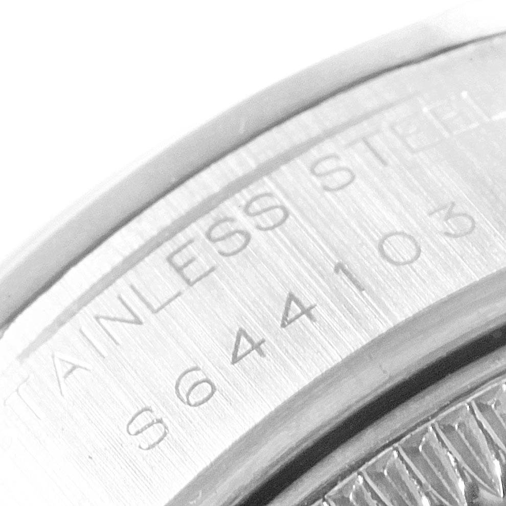 This close-up image shows the engraved serial number on the stainless steel casing of a Rolex Date 69160 Women's Stainless Steel Blue Dial 69160 Women's Stainless Steel Blue Dial model watch.