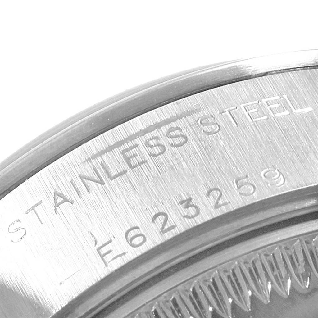 This image shows a close-up of the serial number engraving and part of the stainless steel case back of a Rolex Date 79160 Women's Stainless Steel Pink Dial 79160 Women's Stainless Steel Pink Dial model watch.