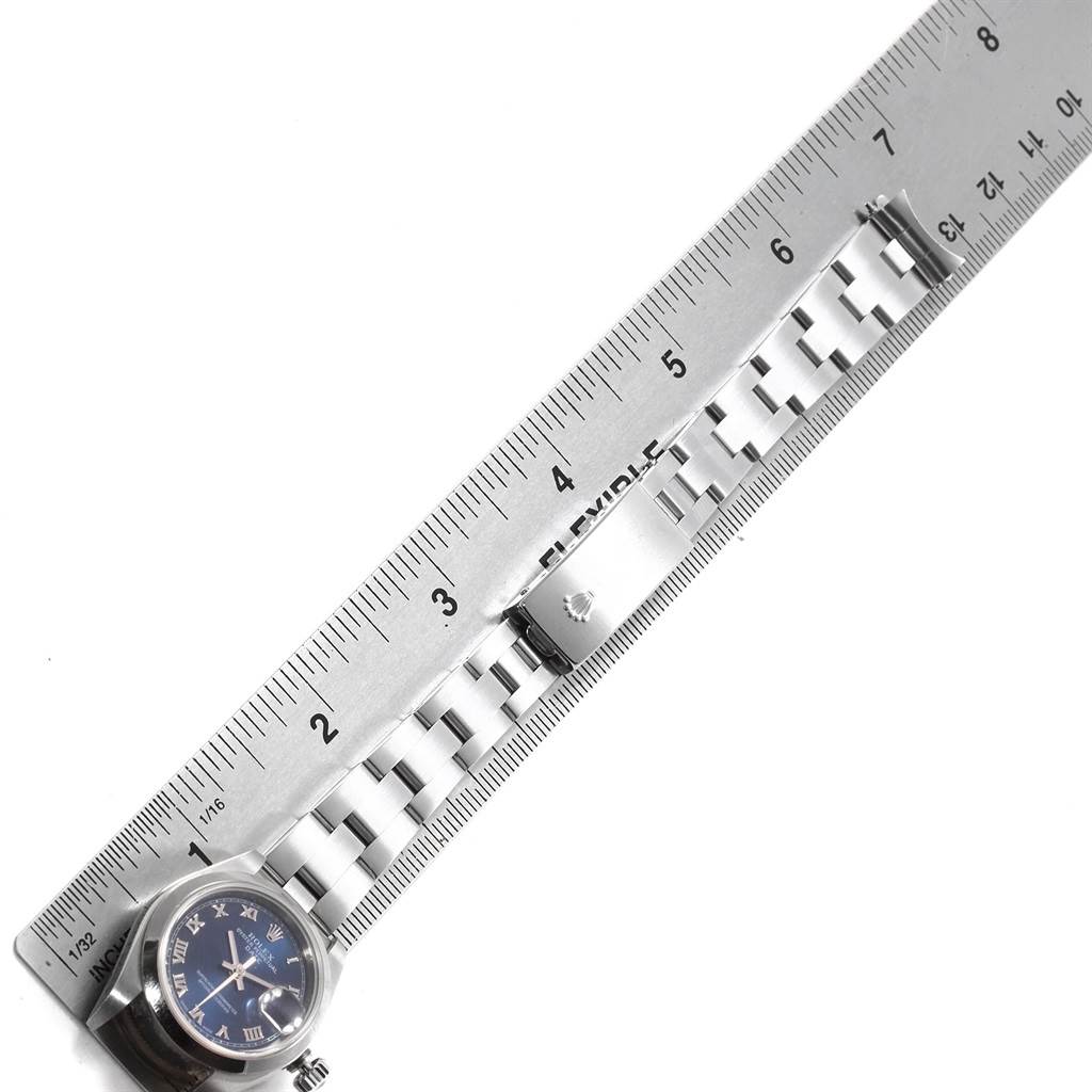 The image shows the side view of a Rolex Date 79160 Women's Stainless Steel Blue Dial 79160 Women's Stainless Steel Blue Dial model watch, highlighting its face and band with a ruler for scale.