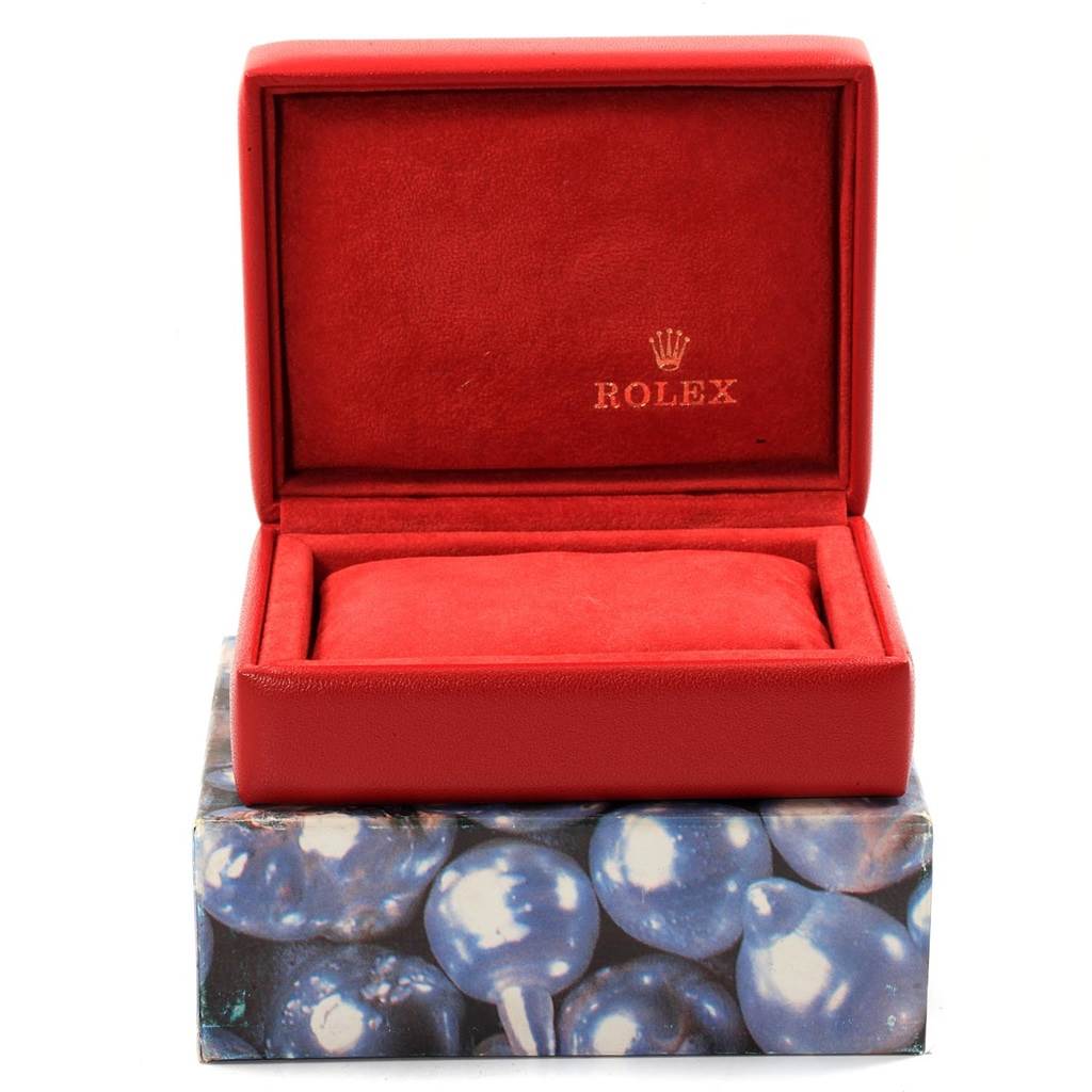 This is an empty, red Rolex Date 79160 Women's Stainless Steel Blue Dial 79160 Women's Stainless Steel Blue Dial watch box, showing the interior padding and the Rolex logo.
