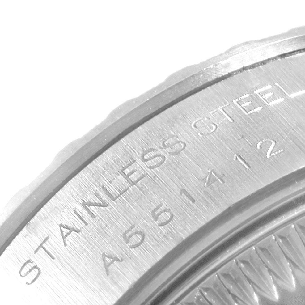 The image shows an extreme close-up of the edge and engraving on the back case of a Rolex Date 79240 Women's Stainless Steel White Dial 79240 Women's Stainless Steel White Dial model watch.