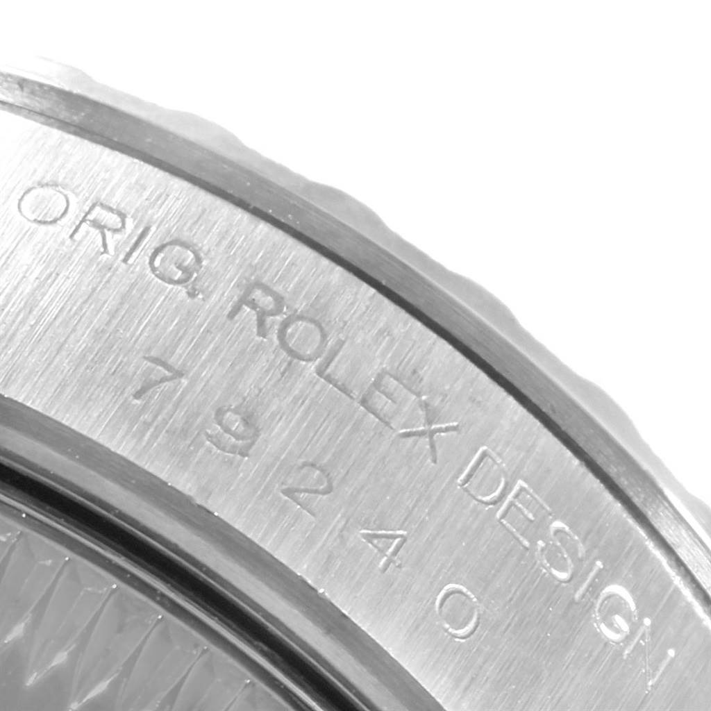 The image shows an angled close-up of the engraved bezel of a Rolex Date 79240 Women's Stainless Steel White Dial 79240 Women's Stainless Steel White Dial model watch.