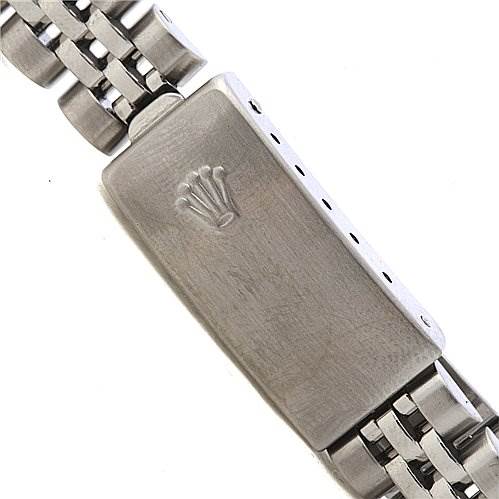 The image shows the clasp of a Rolex Date 79160 Women's Stainless Steel White Dial 79160 Women's Stainless Steel White Dial model watch band from a top-down angle, featuring the Rolex crown logo.