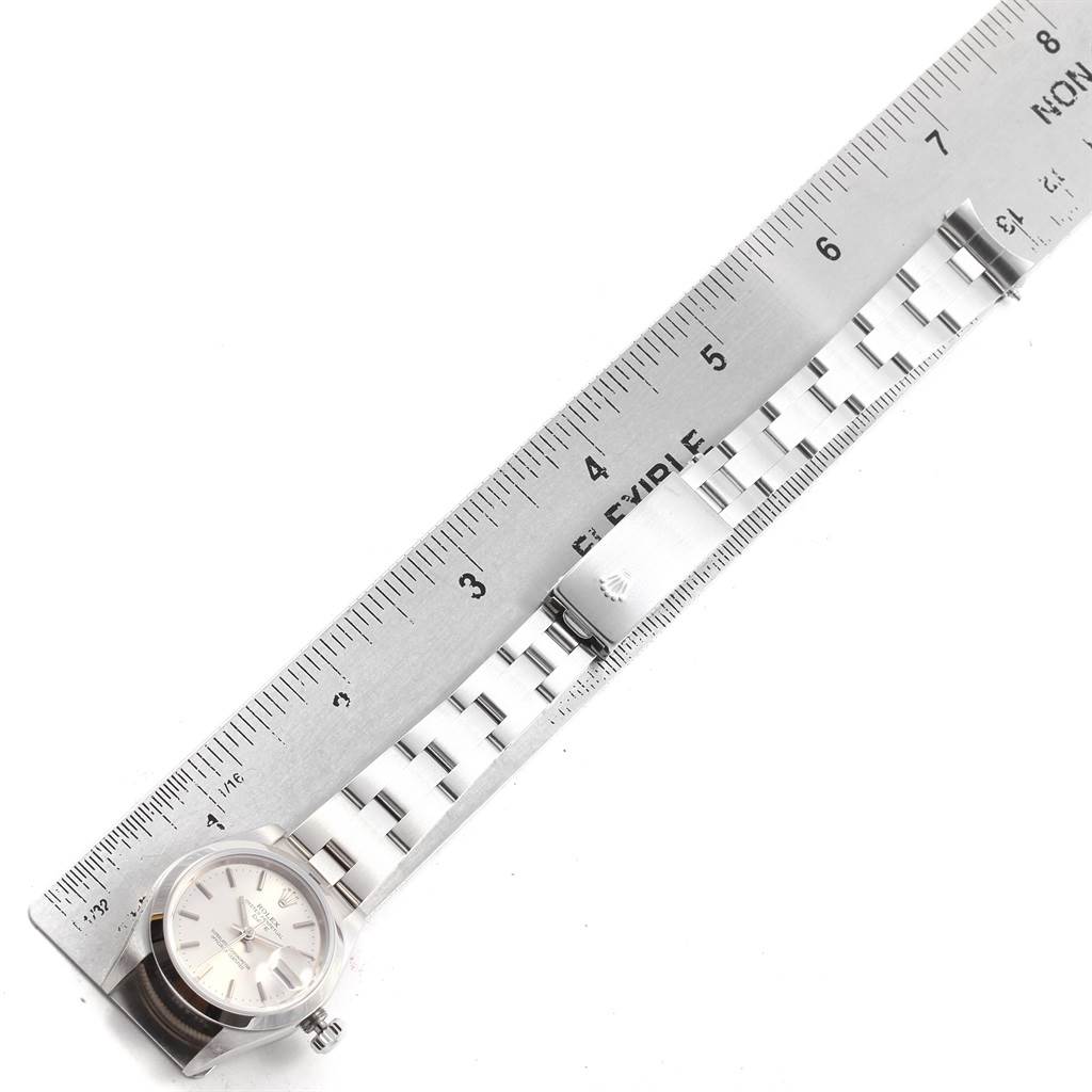 The image shows a Rolex Date 79160 Women's Stainless Steel Silver Dial 79160 Women's Stainless Steel Silver Dial model watch laid flat next to a ruler, displaying the face, bracelet, and clasp from a top-down angle.