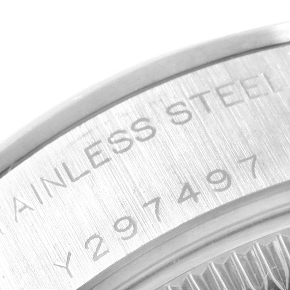 The image shows a close-up of the serial number and "STAINLESS STEEL" engraving on a Rolex Date 79160 Women's Stainless Steel Silver Dial 79160 Women's Stainless Steel Silver Dial model watch case.