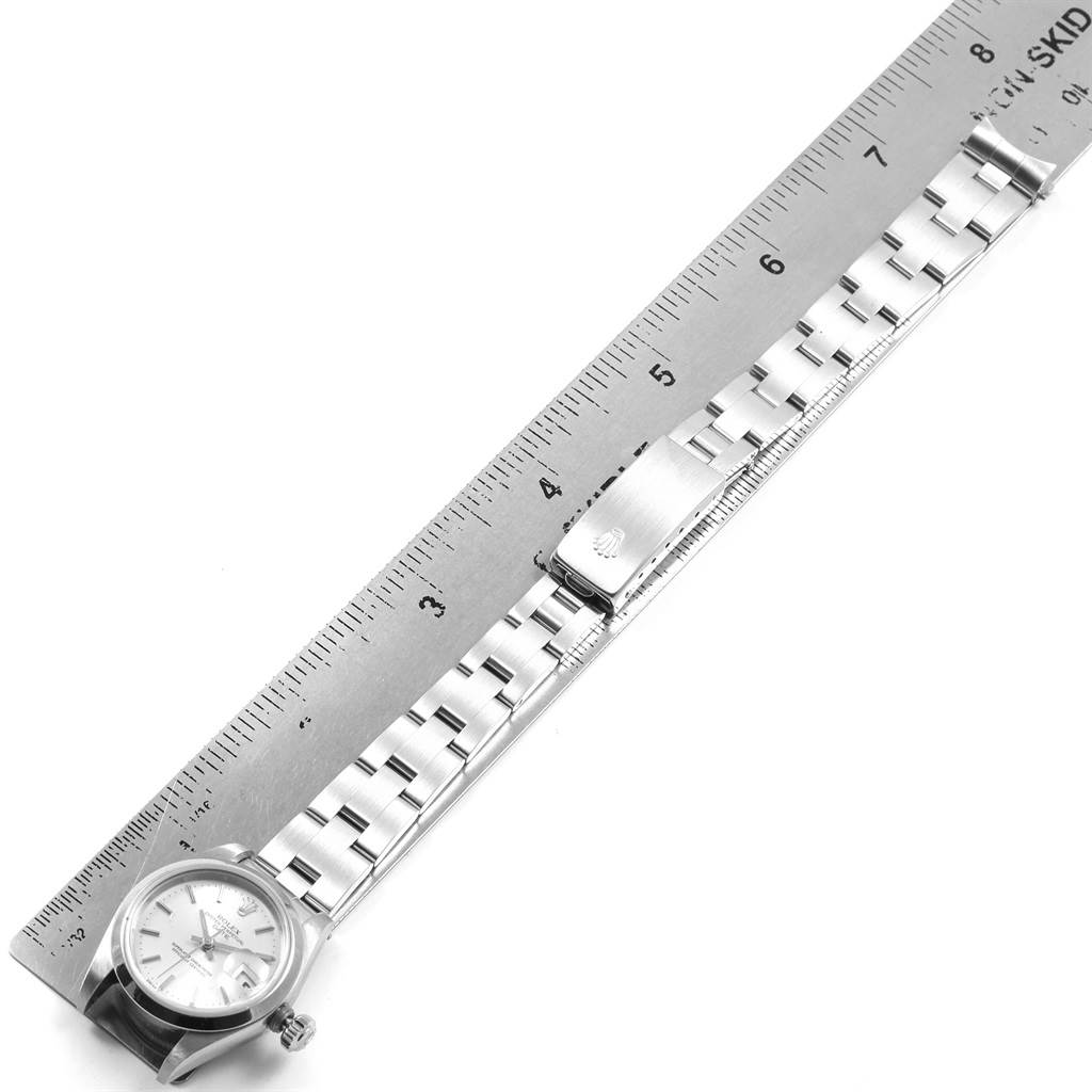 The image shows a Rolex Date 69160 Women's Stainless Steel Silver Dial 69160 Women's Stainless Steel Silver Dial model watch laid flat alongside a ruler, displaying the watch face, band, and clasp.
