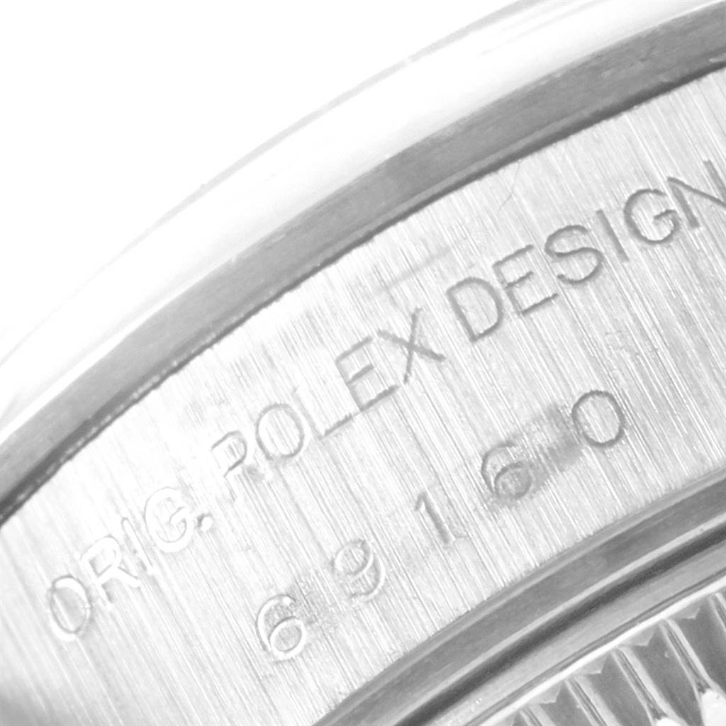 This is a close-up of the case back of a Rolex Date 69160 Women's Stainless Steel Blue Dial 69160 Women's Stainless Steel Blue Dial model, showing the engraving "ORIG. ROLEX DESIGN" and model number.