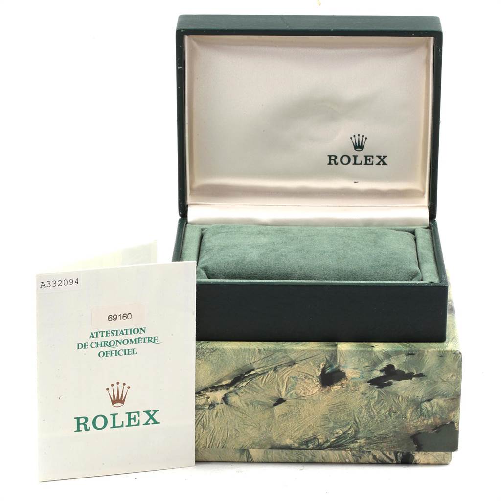 The image shows the packaging and warranty paperwork for a Rolex Date 69160 Women's Stainless Steel Blue Dial 69160 Women's Stainless Steel Blue Dial model, including an open watch box and documentation.