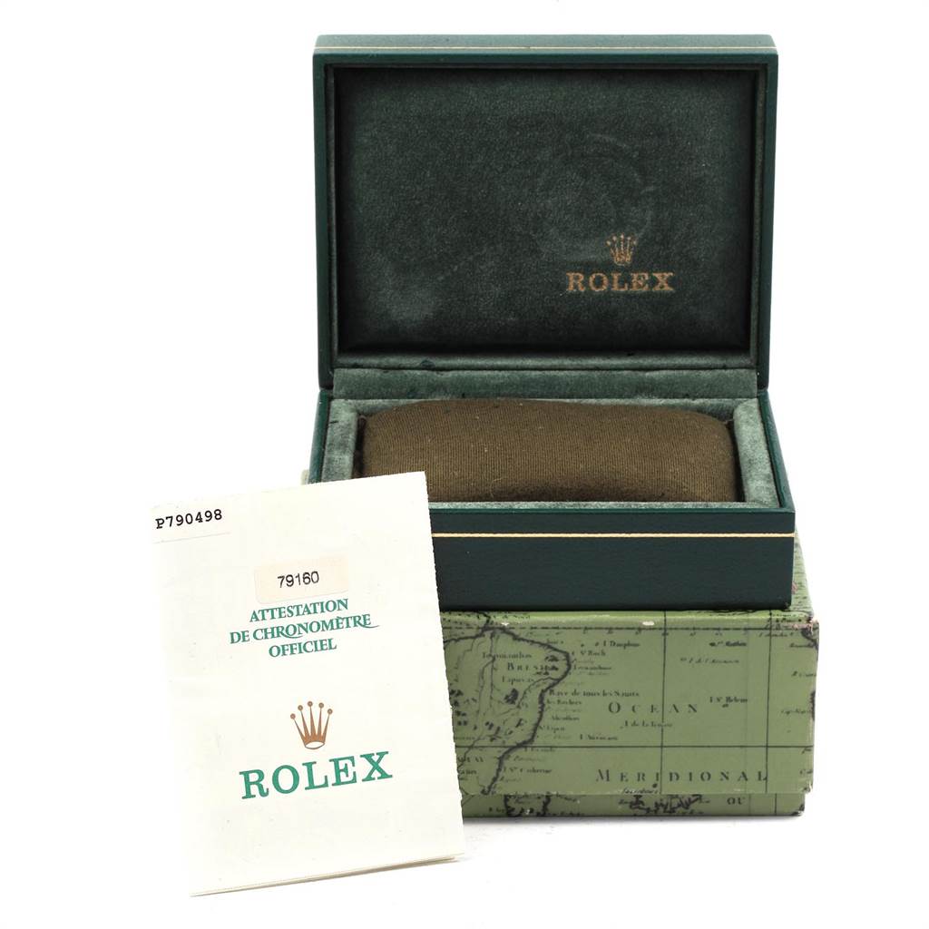 The image shows a green Rolex Date 79160 Women
s Stainless Steel Black Dial 79160 Women
s Stainless Steel Black Dial watch box, open, with an official chronometer certificate booklet leaning against it.