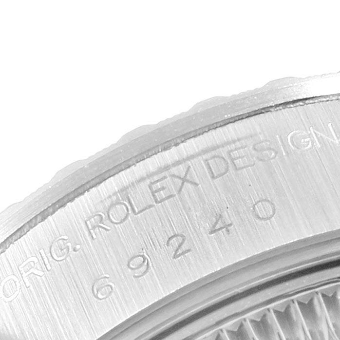 This image shows a close-up of the case back of a Rolex Date 69240 Women's Stainless Steel Silver Dial 69240 Women's Stainless Steel Silver Dial model watch, revealing the engraved text and reference number.