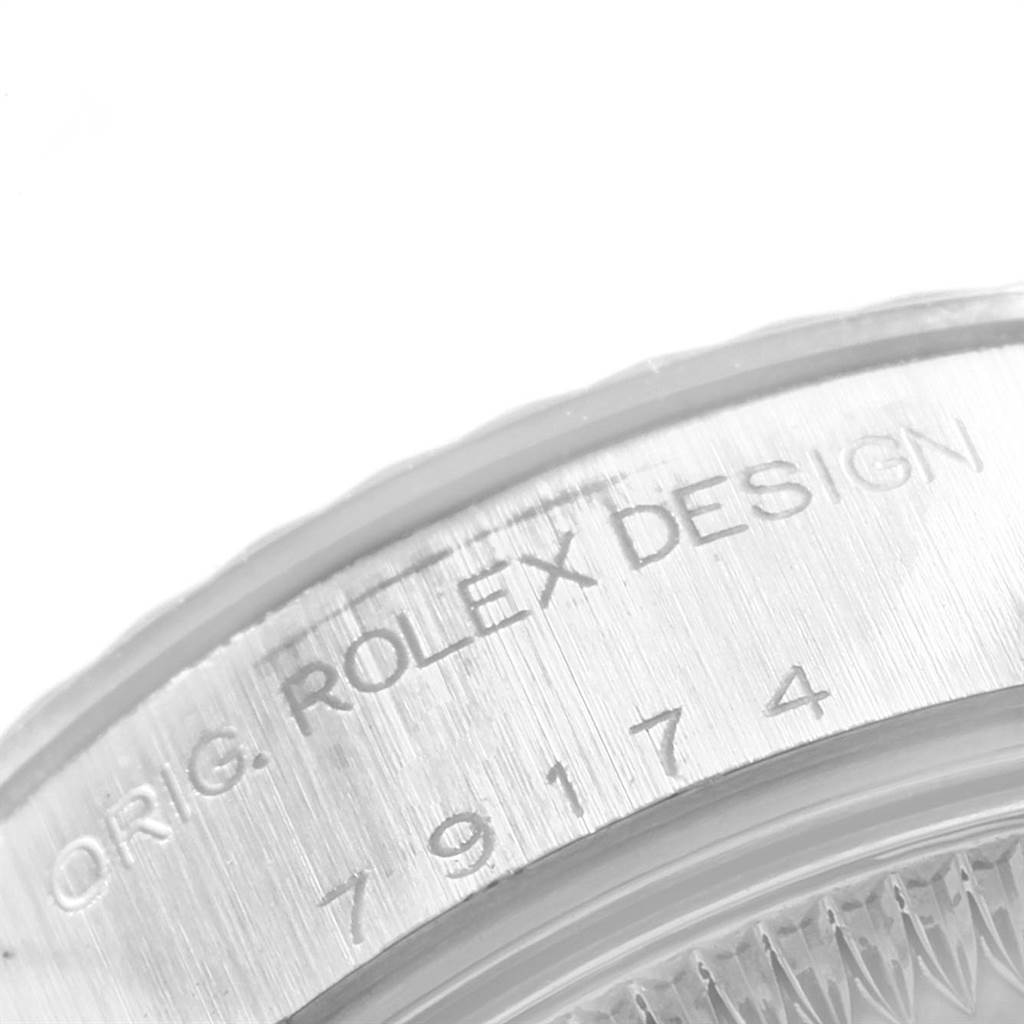 This image shows a close-up of the serial number engraving on the side of a Rolex Date 79174 Women's Stainless Steel Silver Dial 79174 Women's Stainless Steel Silver Dial watch case.
