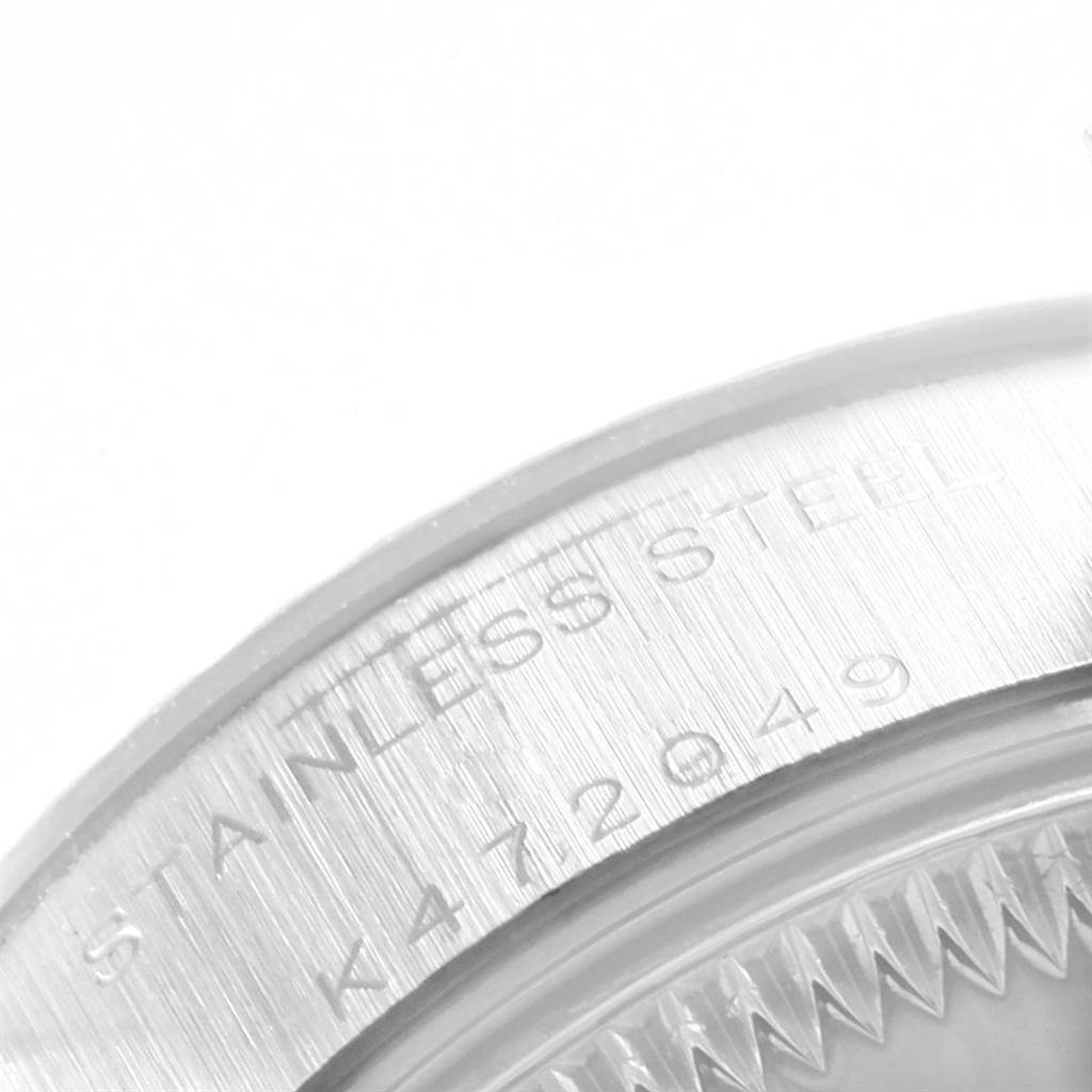 A close-up image of the case back of a Rolex Date 79174 Women's Stainless Steel Silver Dial 79174 Women's Stainless Steel Silver Dial model, showing the stainless steel inscription and part of the serial number.