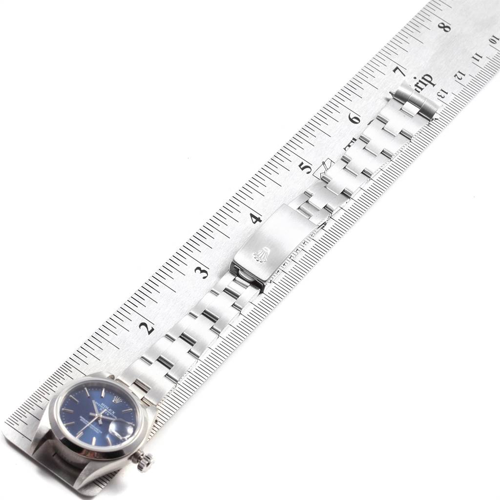 The image shows a Rolex Date 79160 Women's Stainless Steel Blue Dial 79160 Women's Stainless Steel Blue Dial model watch with a stainless steel bracelet laid alongside a ruler.