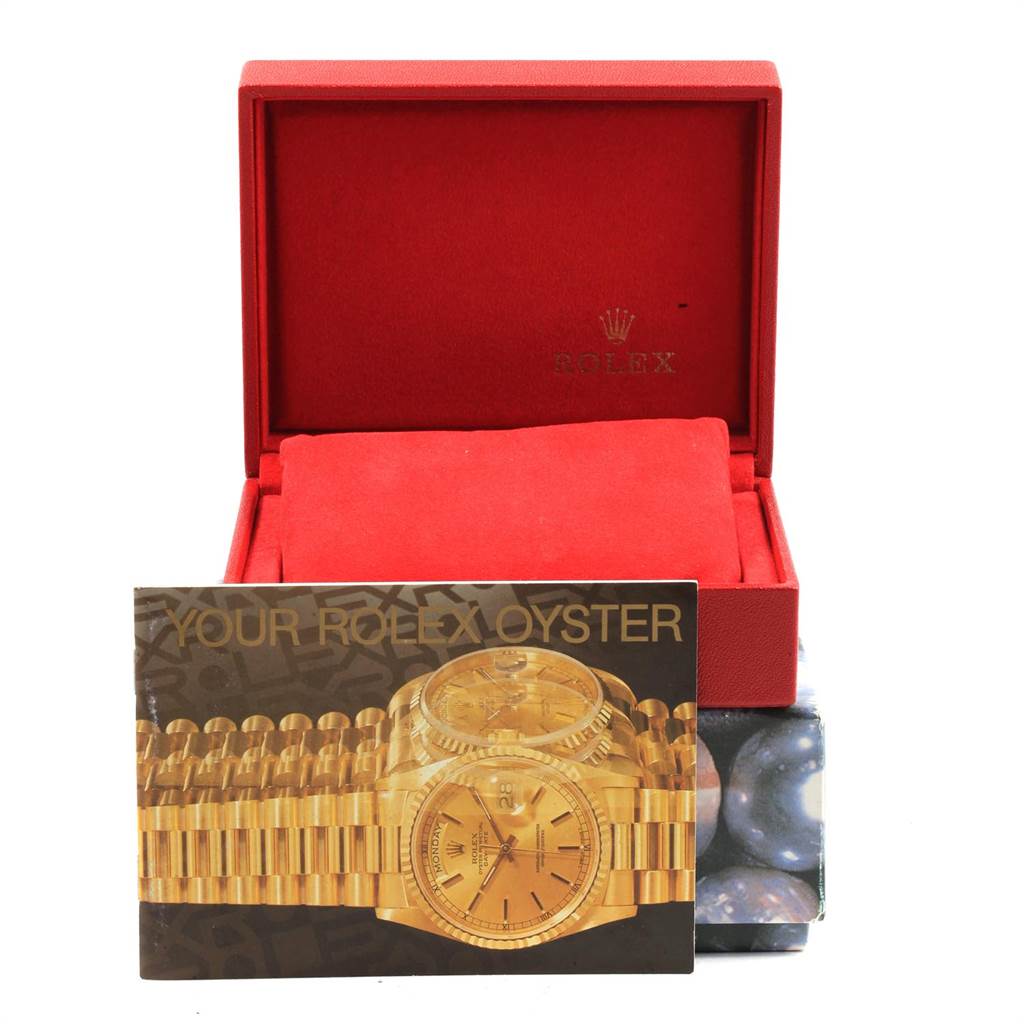 The image shows a red Rolex box and a booklet for the Rolex Date 79160 Women's Stainless Steel Blue Dial 79160 Women's Stainless Steel Blue Dial model.