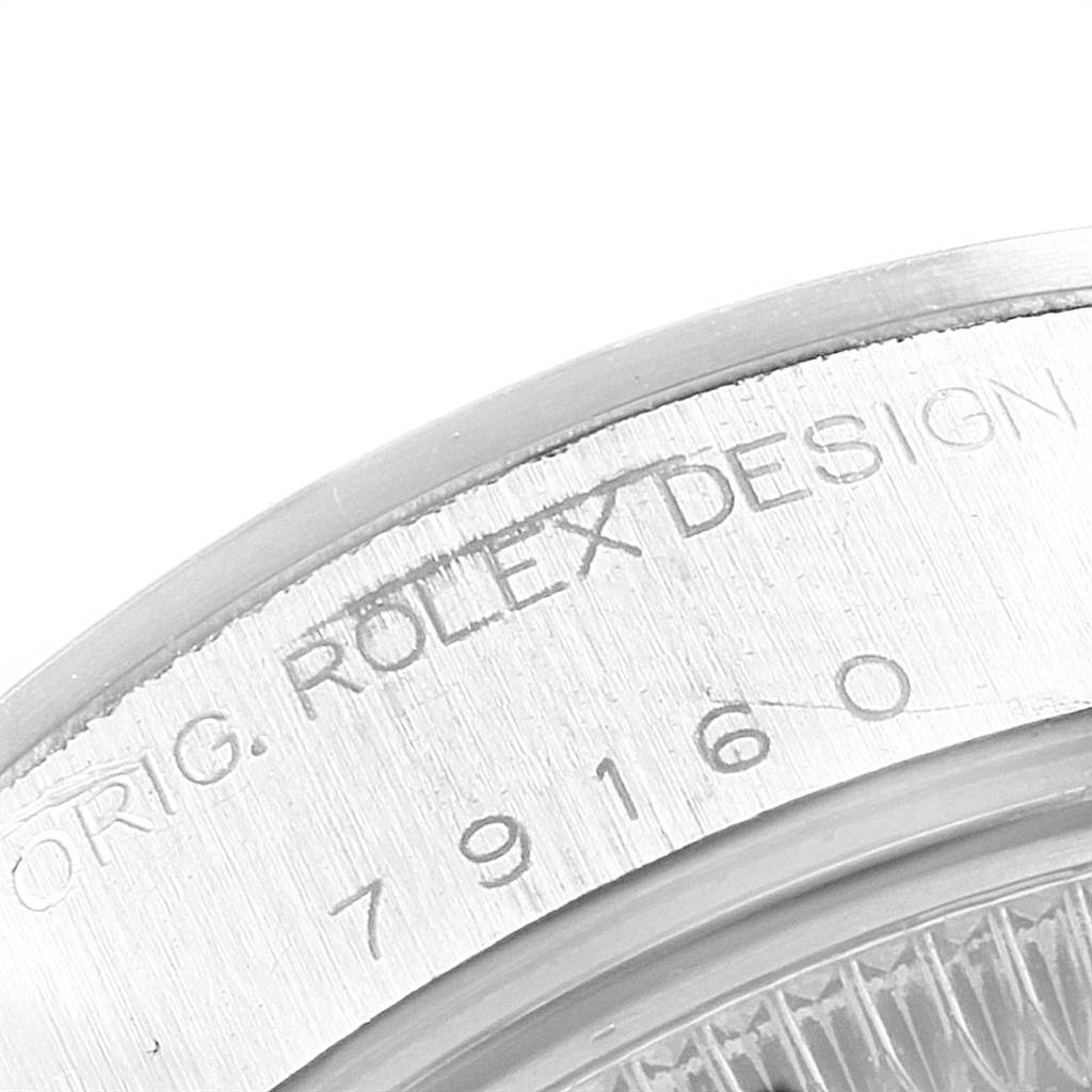The image shows a close-up of the case side of a Rolex Date 79160 Women's Stainless Steel Blue Dial 79160 Women's Stainless Steel Blue Dial model, displaying the engraved "Rolex Design" with model number 79160.