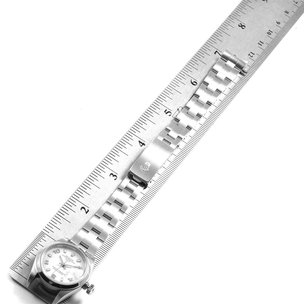The image shows a Rolex Date 79160 Women's Stainless Steel White Dial 79160 Women's Stainless Steel White Dial model watch with its bracelet laid alongside a ruler, displaying its clasp and links.